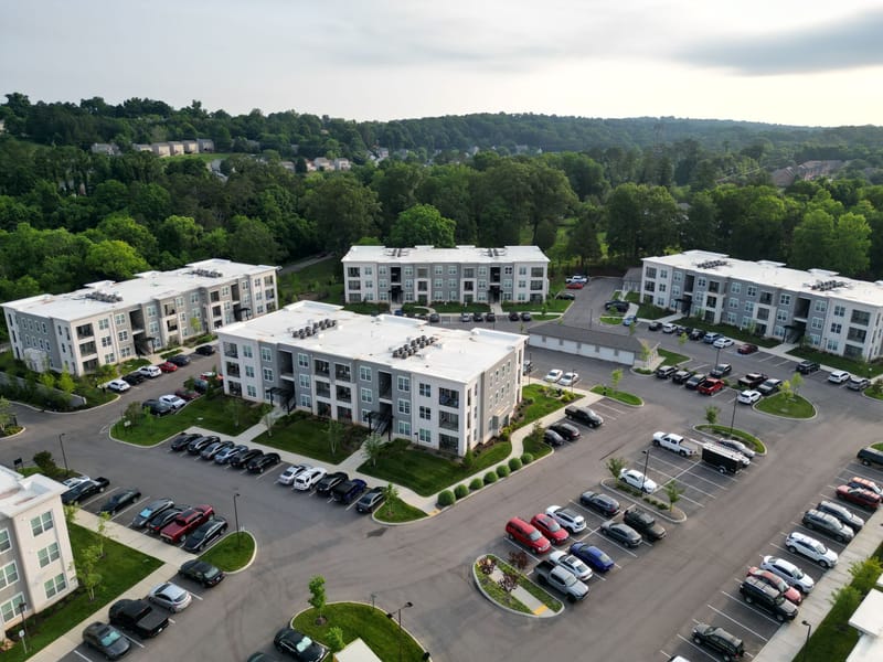 Several three-storey apartment buildings around a shared parking court