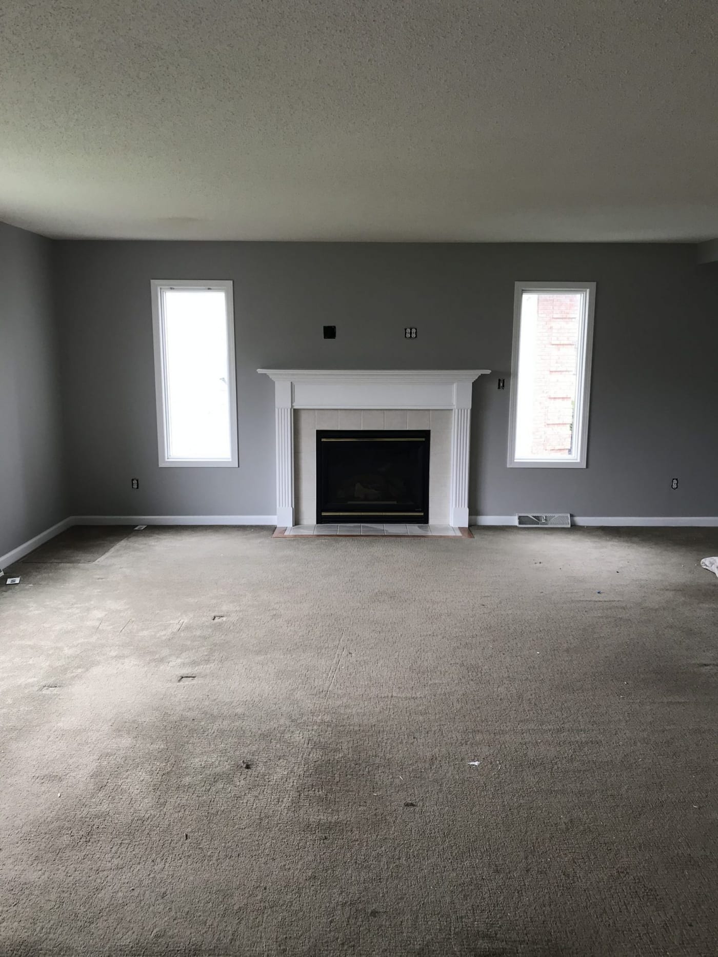 Living room and fireplace wall — after
