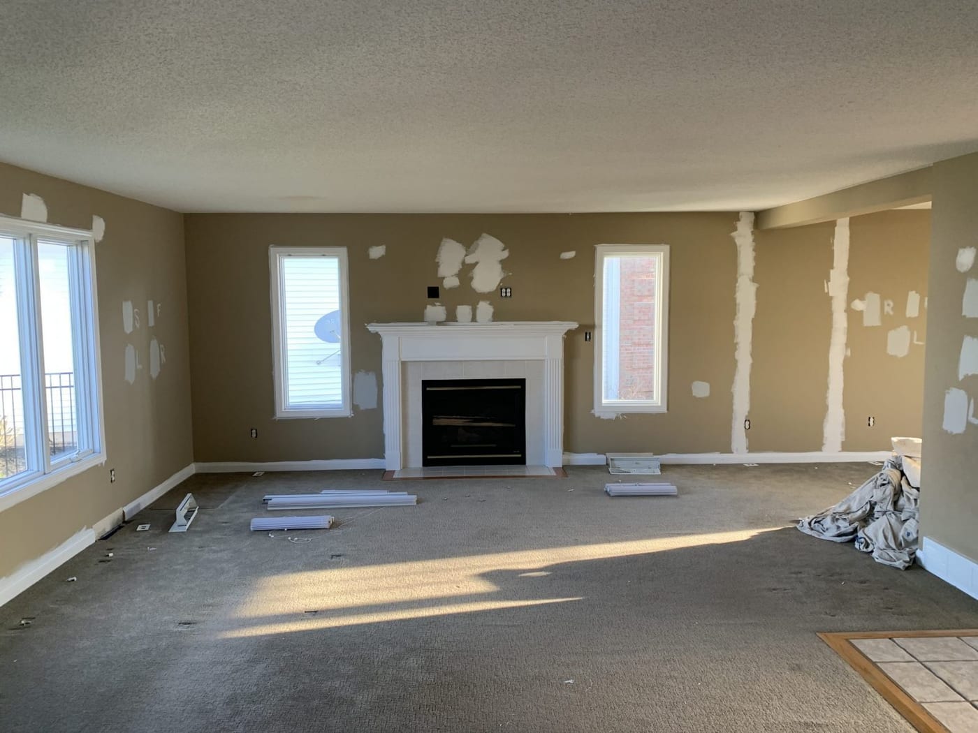 Living room and fireplace wall — before