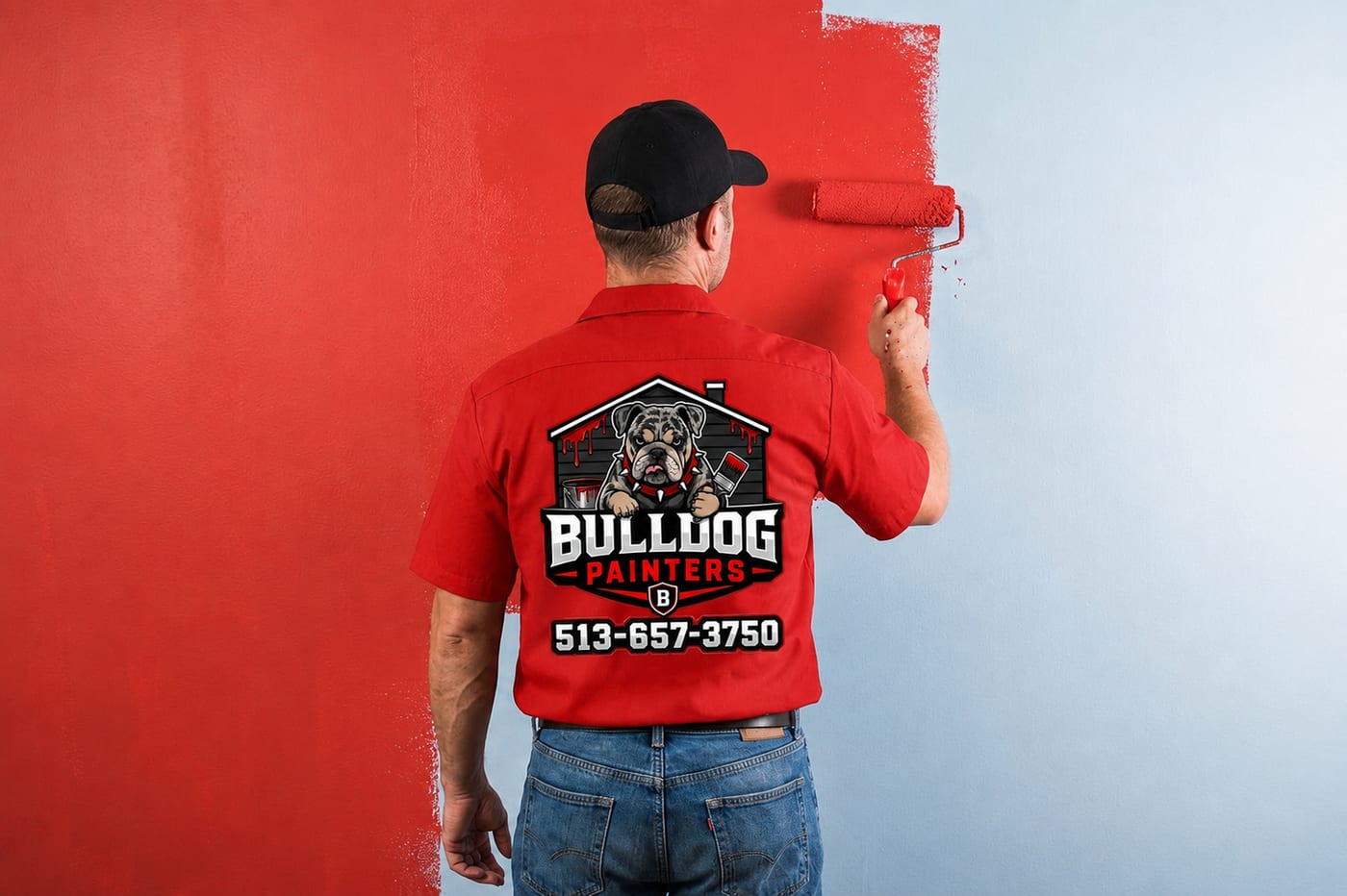 A Bulldog Painters painter rolling a wall with a roller on an extension frame